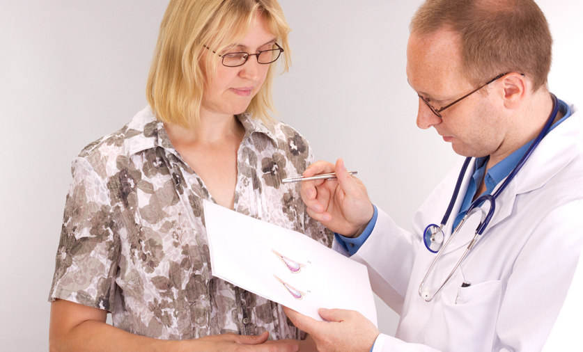 woman at doctors office considering breast surgery