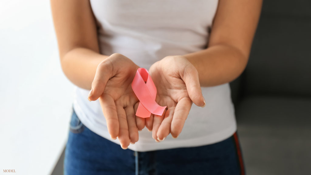 woman holding breast cancer awareness ribbon